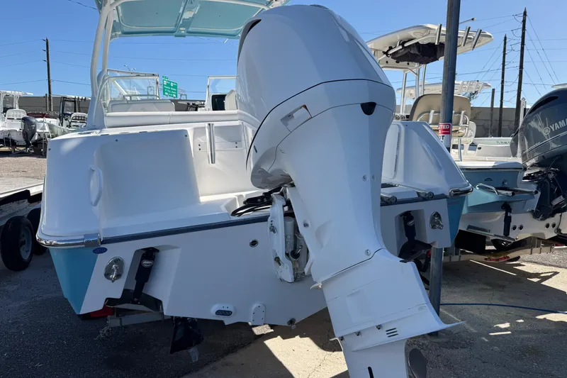 Slide: The Image of 2017 Edgewater 248CX Crossover boat with outboard motor, displayed in a marina setting. - 4