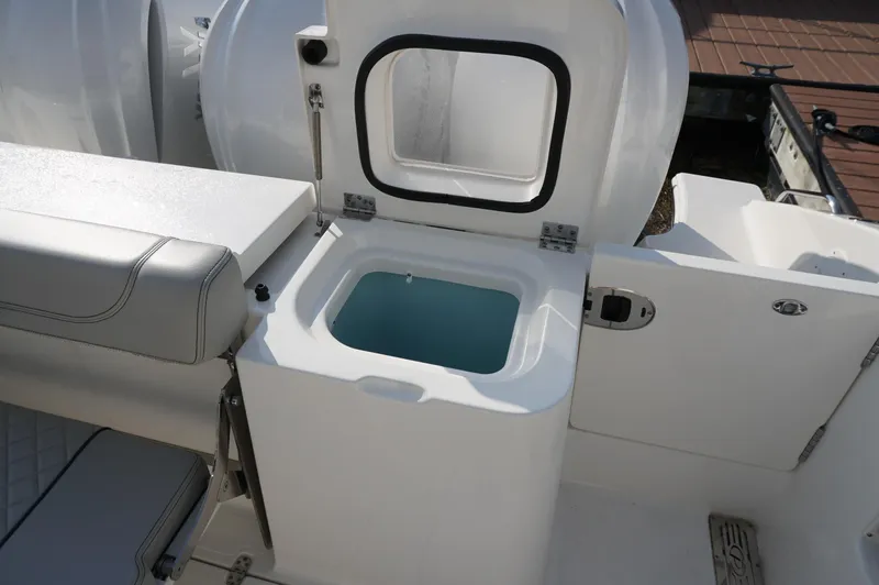 Slide: The Image of 2023 Pursuit OS 355 Offshore boat with open storage compartment and seating area. - 19
