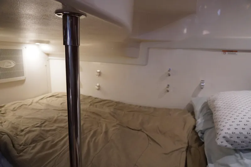 Slide: The Image of 2023 Pursuit OS 355 Offshore cabin interior with bed and pillow. - 37