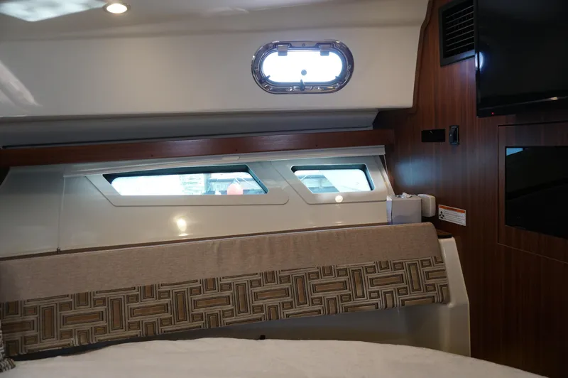 Slide: The Image of 2023 Pursuit OS 355 Offshore cabin interior with windows and modern decor. - 43