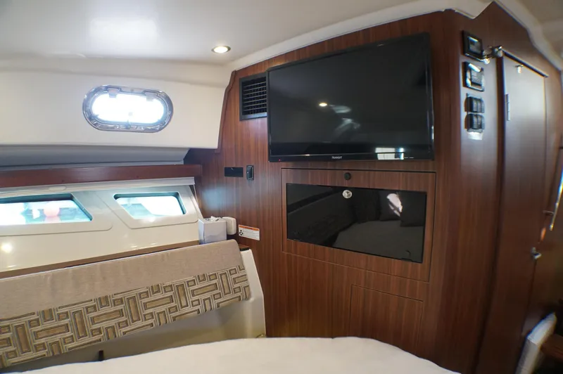 Slide: The Image of 2023 Pursuit OS 355 Offshore cabin interior with TV and window. - 45