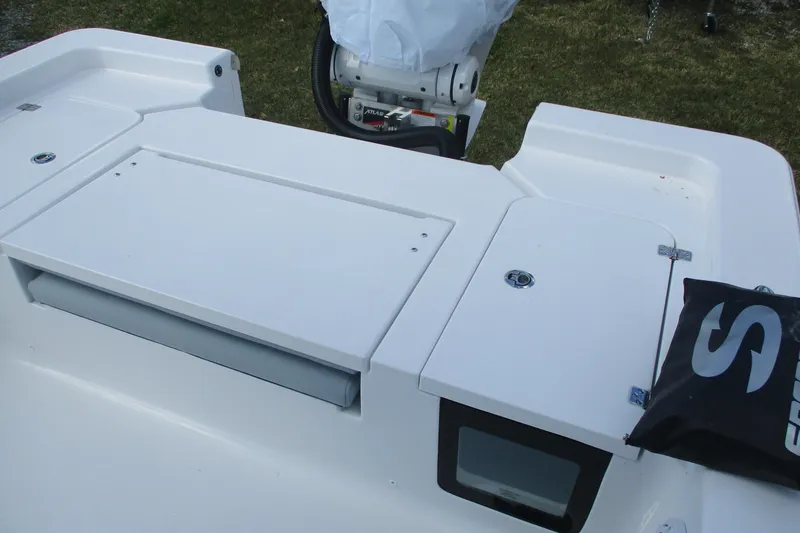 Slide: The Image of 2026 Sportsman Masters 247 Bay Boat deck with storage compartments and motor. - 13