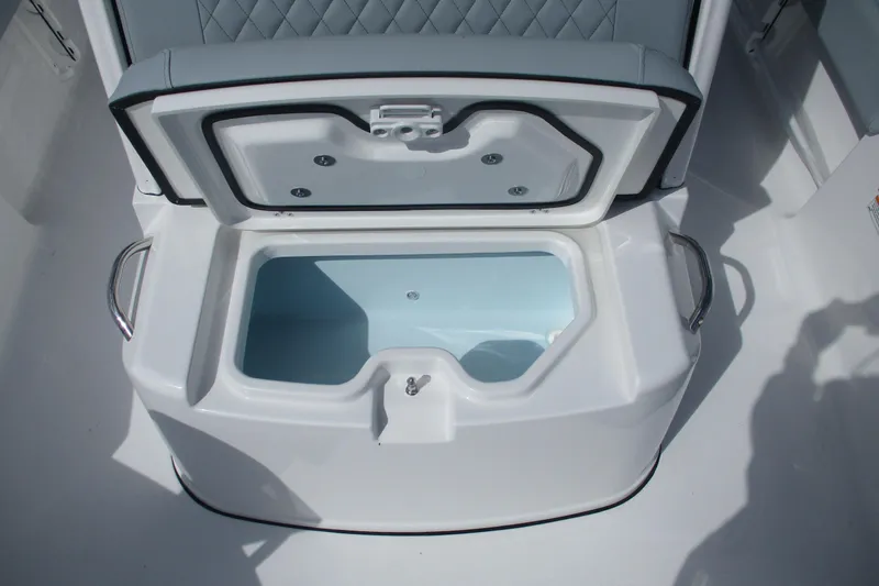 Slide: The Image of Open storage compartment on 2026 Sportsman Masters 247 Bay Boat with cushioned seating. - 15