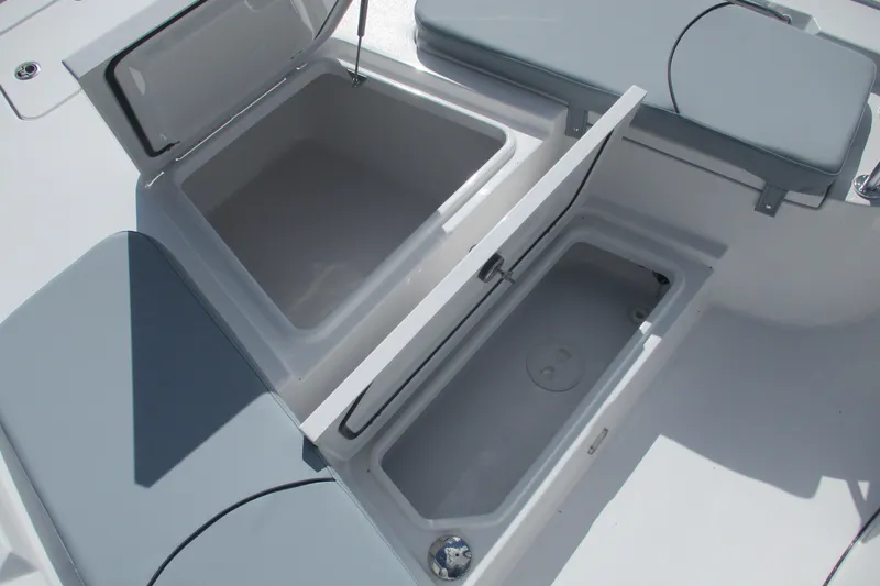 Slide: The Image of 2026 Sportsman Masters 247 Bay Boat storage compartments with cushioned seating. - 18