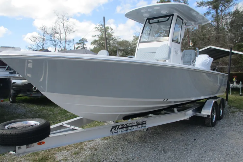 Slide: The Image of 2026 Sportsman Masters 247 Bay Boat on trailer, parked outdoors under a cloudy sky. - 3