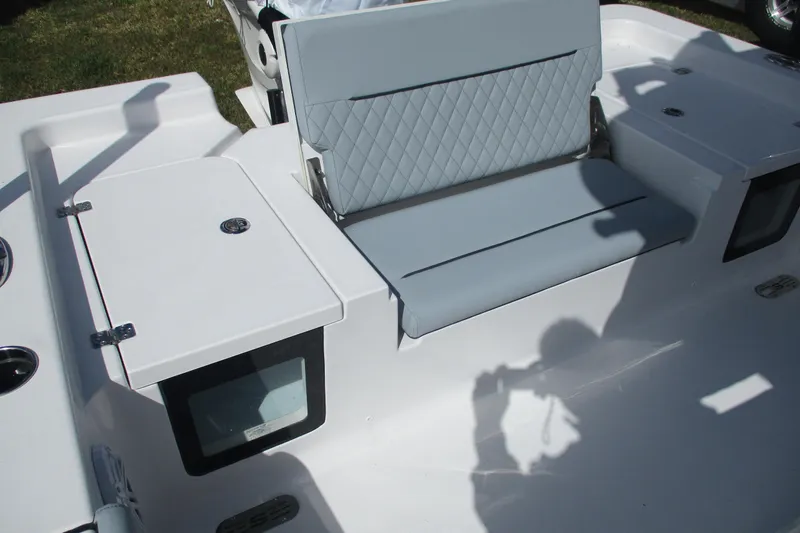 Slide: The Image of 2026 Sportsman Masters 247 Bay Boat interior with cushioned seating and storage compartments. - 4