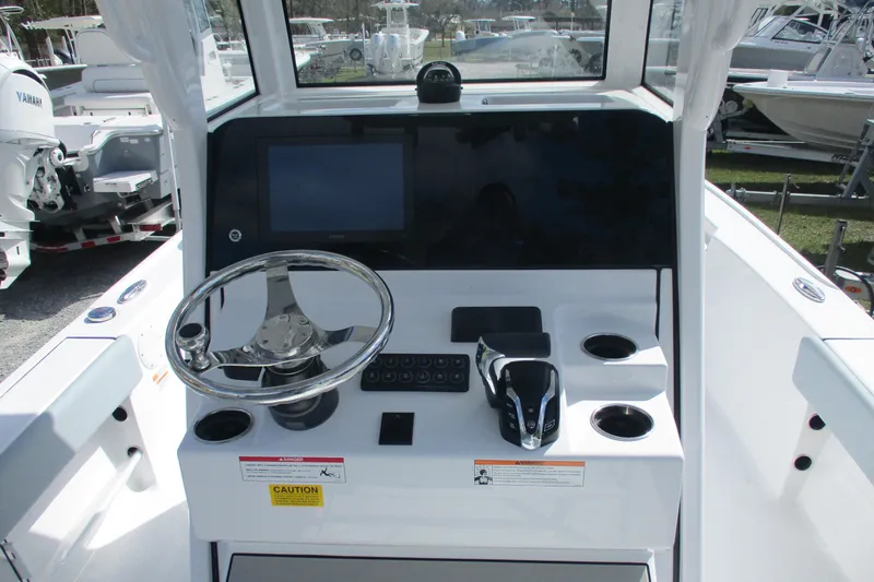 Slide: The Image of 2026 Sportsman Masters 247 Bay Boat dashboard with steering wheel and controls. - 5