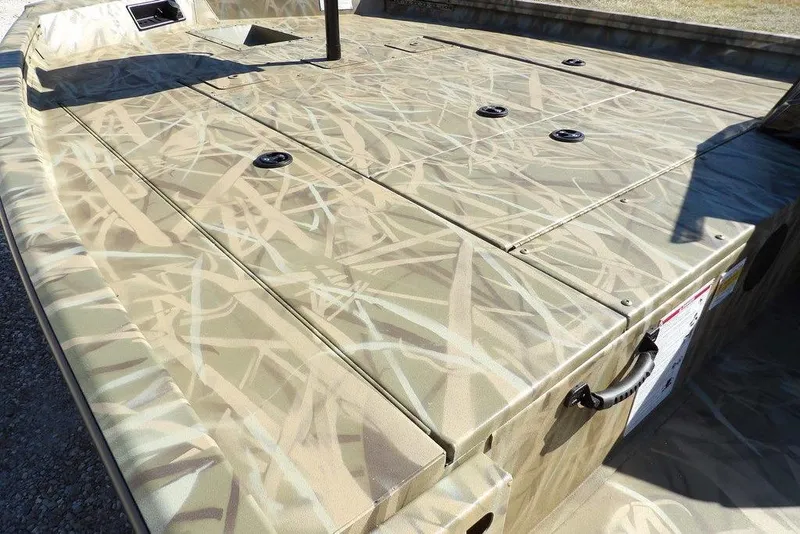 Slide: The Image of 2026 Crestliner XFC 189 boat with camouflage deck design, featuring storage compartments. - 10