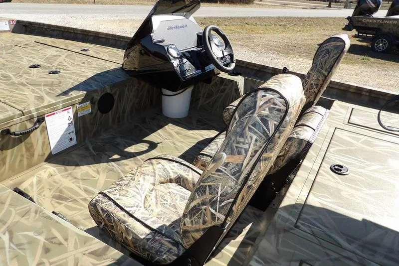 Slide: The Image of 2026 Crestliner XFC 189 boat interior with camouflage seats and steering console. - 12