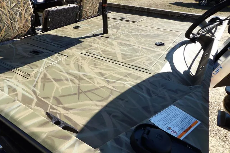 Slide: The Image of 2026 Crestliner XFC 189 boat deck with camouflage pattern and storage compartments. - 13