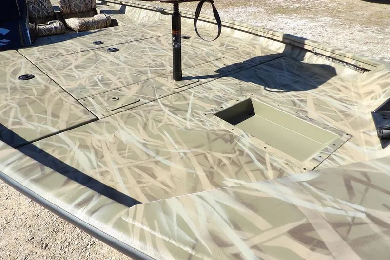 Slide: The Image of 2026 Crestliner XFC 189 boat with camouflage deck design, featuring spacious seating and storage. - 14