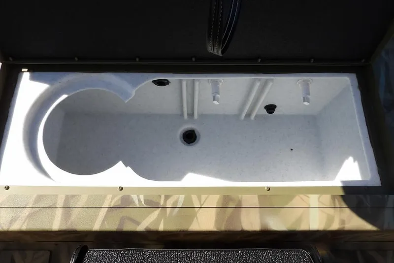 Slide: The Image of 2026 Crestliner XFC 189 livewell interior with white finish and drainage system. - 16