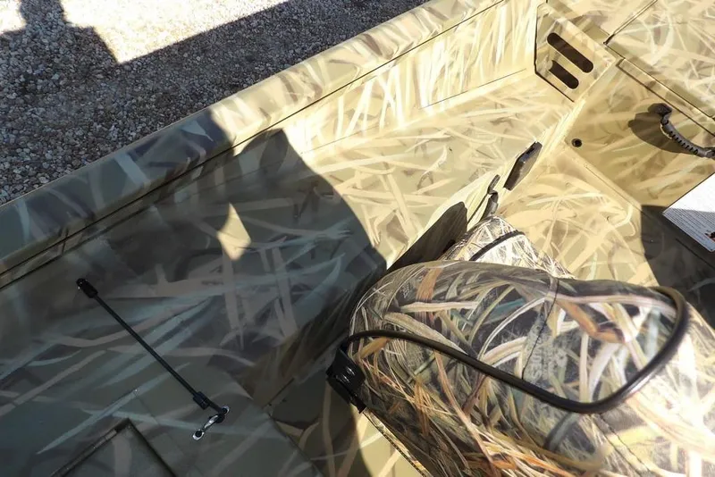 Slide: The Image of 2026 Crestliner XFC 189 boat interior with camouflage design and seating. - 18