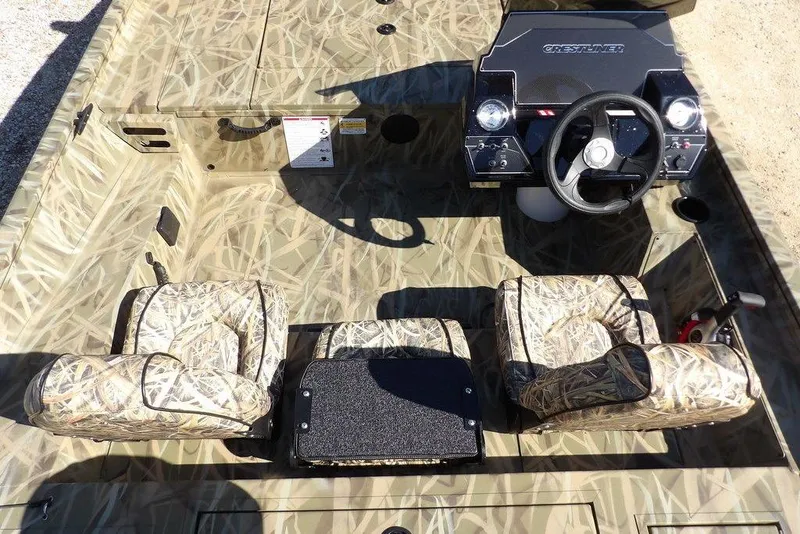 Slide: The Image of 2026 Crestliner XFC 189 boat interior with camouflage seats and steering console. - 19
