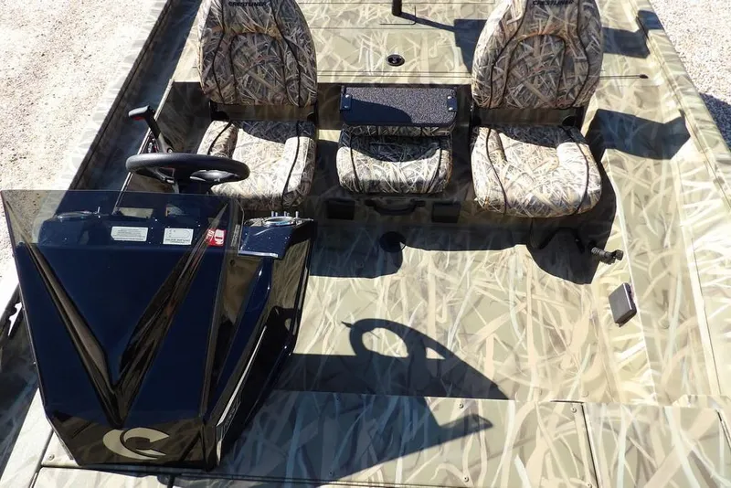 Slide: The Image of 2026 Crestliner XFC 189 boat interior with camouflage seats and steering console. - 21