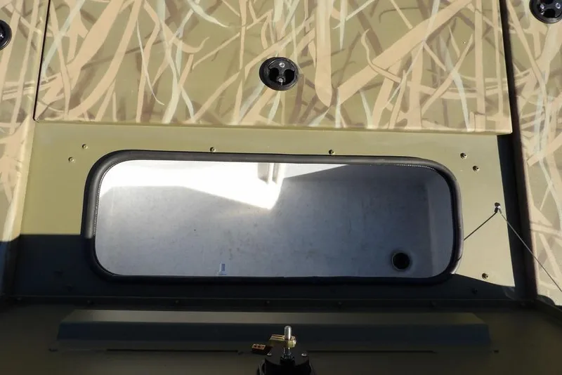 Slide: The Image of 2026 Crestliner XFC 189 boat interior with camouflage design and storage compartment. - 22