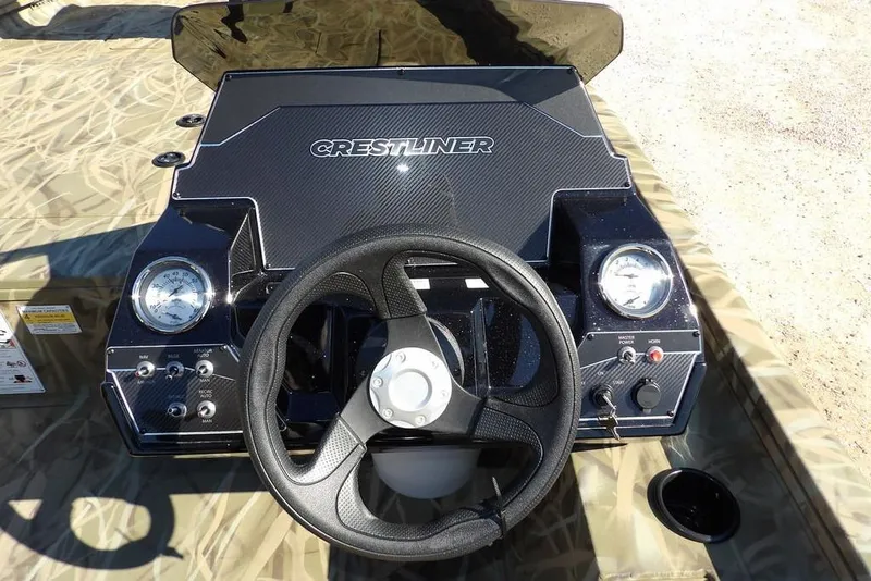 Slide: The Image of 2026 Crestliner XFC 189 boat dashboard with steering wheel and gauges. - 24