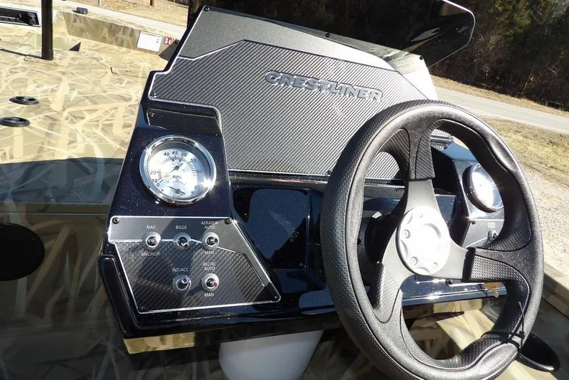 Slide: The Image of 2026 Crestliner XFC 189 boat dashboard with steering wheel and control panel. - 25