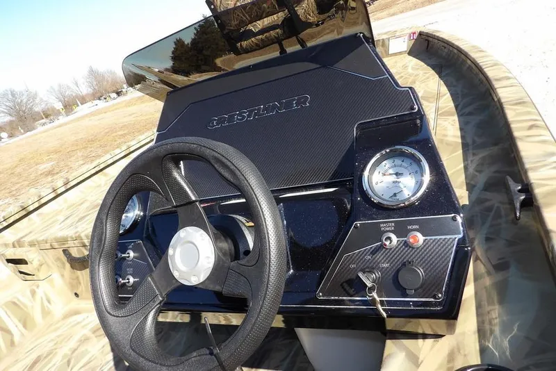 Slide: The Image of 2026 Crestliner XFC 189 boat dashboard with steering wheel and control panel. - 26