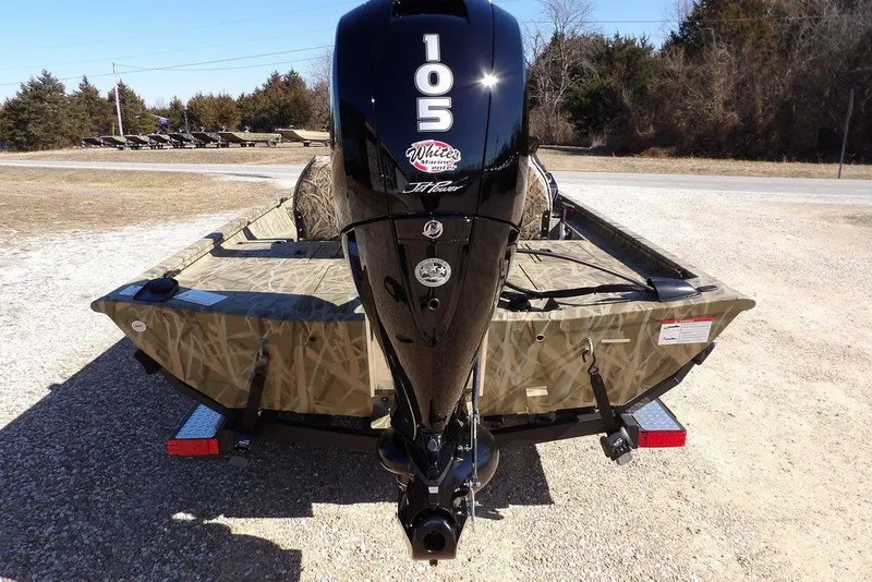 Slide: The Image of 2026 Crestliner XFC 189 boat with 105 horsepower engine, parked on gravel. - 3