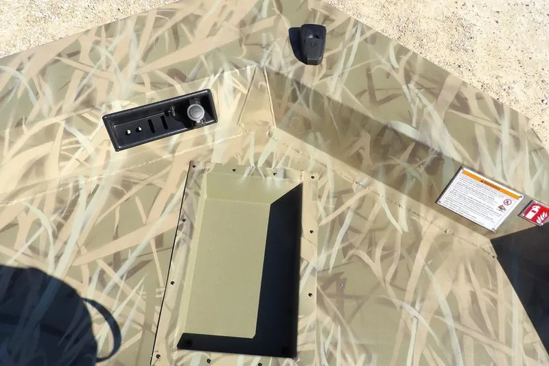 Slide: The Image of 2026 Crestliner XFC 189 boat interior with camouflage design and control panel. - 32