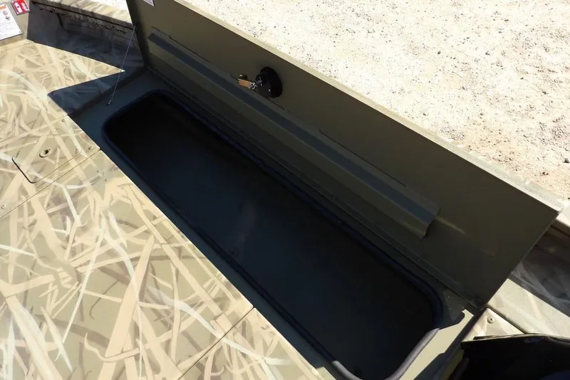 Slide: The Image of Open storage compartment in 2026 Crestliner XFC 189 boat with camouflage design. - 33