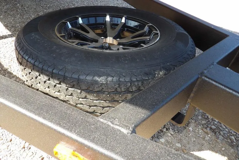 Slide: The Image of 2026 Crestliner XFC 189 trailer with spare tire on gravel surface. - 35