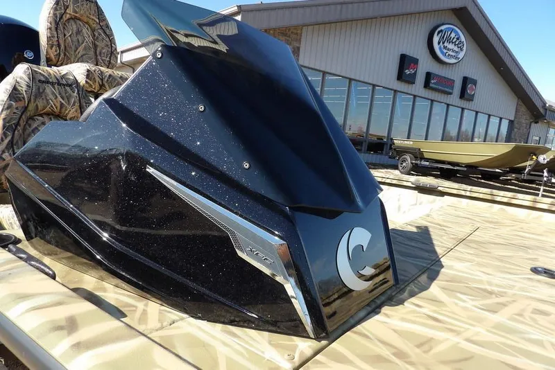 Slide: The Image of 2026 Crestliner XFC 189 boat at dealership, featuring sleek design and camo seats. - 36