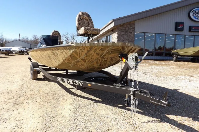 Slide: The Image of 2026 Crestliner XFC 189 boat on trailer outside dealership, sunny day. - 37