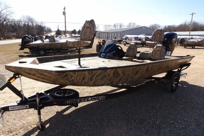 Slide: The Image of 2026 Crestliner XFC 189 fishing boat with camouflage design on a trailer. - 4