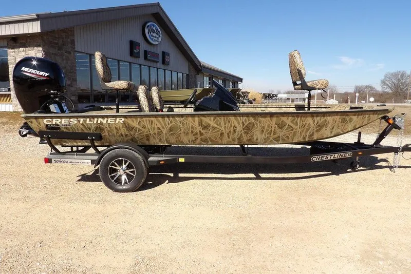 Slide: The Image of 2026 Crestliner XFC 189 fishing boat with camouflage design on a trailer. - 5