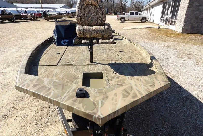 Slide: The Image of 2026 Crestliner XFC 189 boat with camouflage design, parked outdoors. - 6