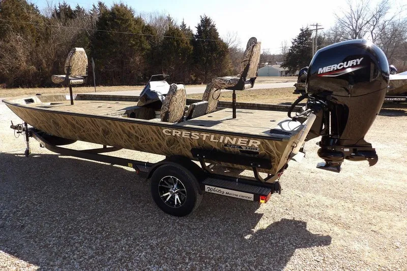 Slide: The Image of 2026 Crestliner XFC 189 fishing boat with Mercury outboard motor, camo design, on a trailer. - 7