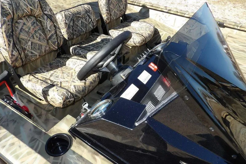 Slide: The Image of 2026 Crestliner XFC 189 boat interior with camo seats and steering wheel. - 8