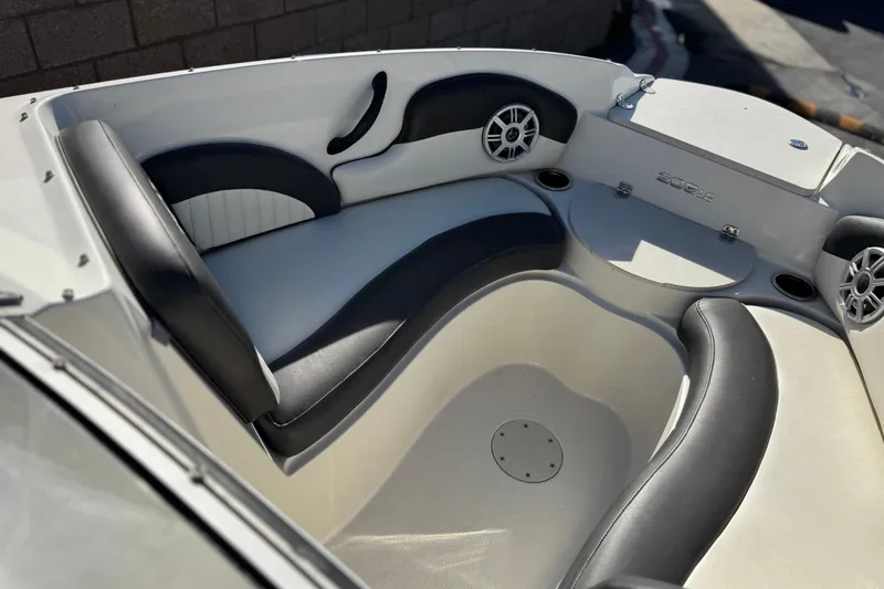 Slide: The Image of 2018 Stingray 208 LS boat interior with black and white seating and speakers. - 14