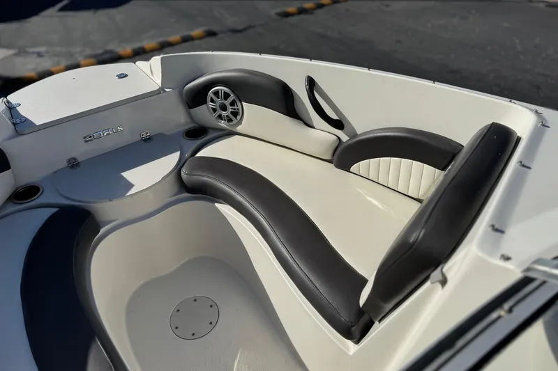 Slide: The Image of 2018 Stingray 208 LS boat interior with black and white seating and speaker. - 15