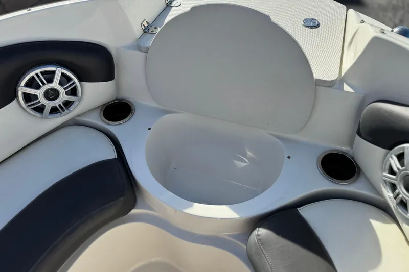 Slide: The Image of Interior of 2018 Stingray 208 LS boat with speakers and cup holders. - 16