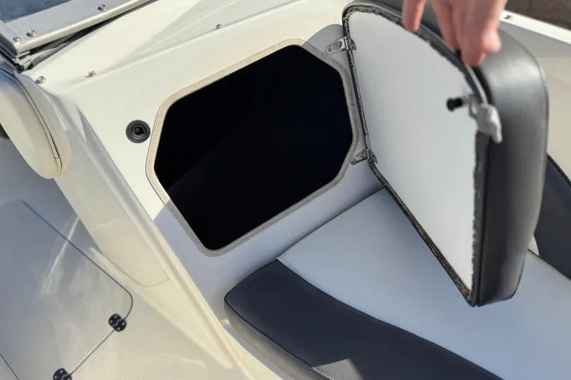 Slide: The Image of Open storage compartment on a 2018 Stingray 208 LS boat, showcasing interior space. - 17