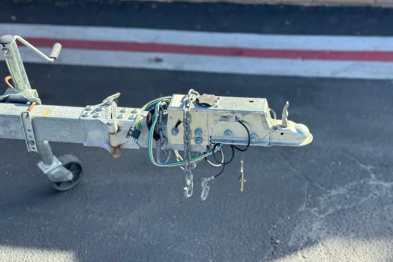 Slide: The Image of Trailer hitch of a 2018 Stingray 208 LS boat on asphalt surface. - 28