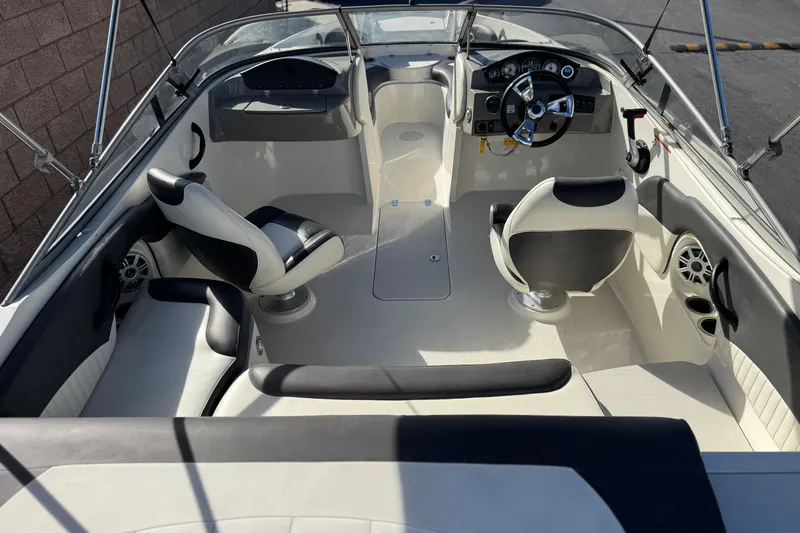 Slide: The Image of 2018 Stingray 208 LS boat interior with steering wheel, seating, and dashboard controls. - 9