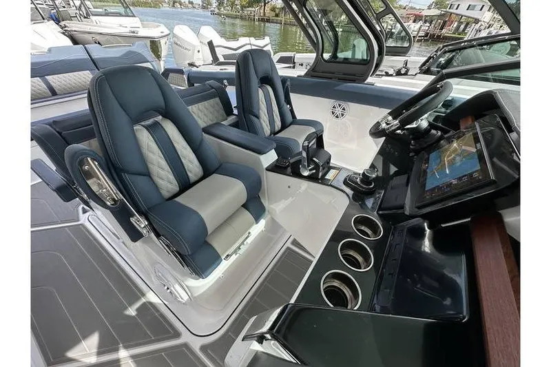 Slide: The Image of Luxurious interior of 2026 Monterey Elite 30 OB boat with modern seating and navigation system. - 5