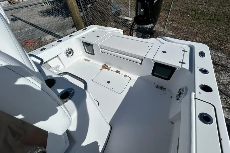 Slide: The Image of 2026 Sportsman Masters 267OE Bay Boat interior with storage compartments and cup holders. - 11