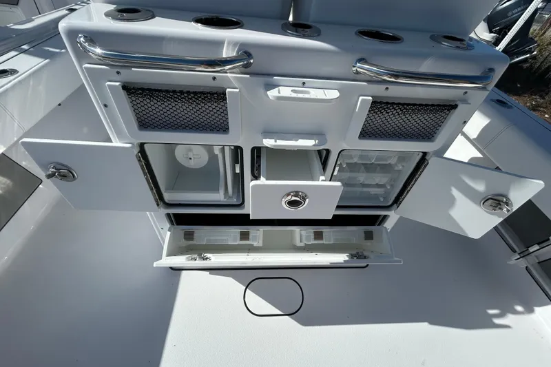 Slide: The Image of 2026 Sportsman Masters 267OE Bay Boat interior with storage compartments and cup holders. - 14