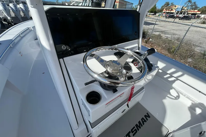 Slide: The Image of 2026 Sportsman Masters 267OE Bay Boat helm with steering wheel and controls. - 4