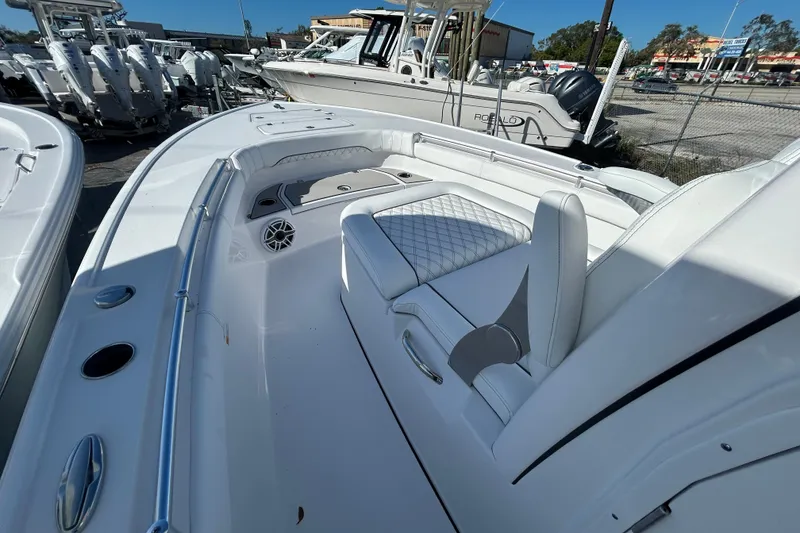 Slide: The Image of 2026 Sportsman Masters 267OE Bay Boat interior with white seating and sleek design. - 6