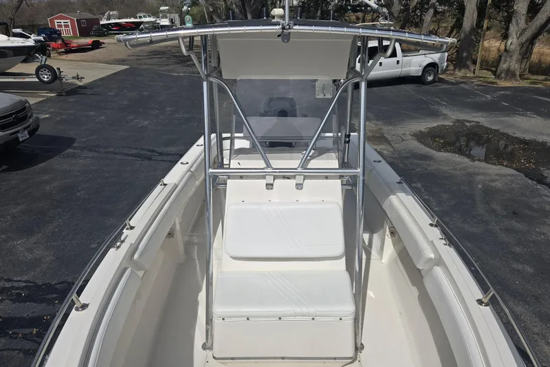 Slide: The Image of 1998 Fountain 25 Center Console boat with T-top and seating, parked outdoors. - 10