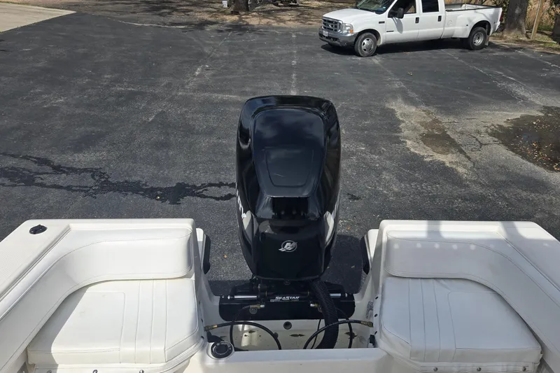 Slide: The Image of 1998 Fountain 25 Center Console boat with Mercury outboard motor, parked on asphalt. - 12