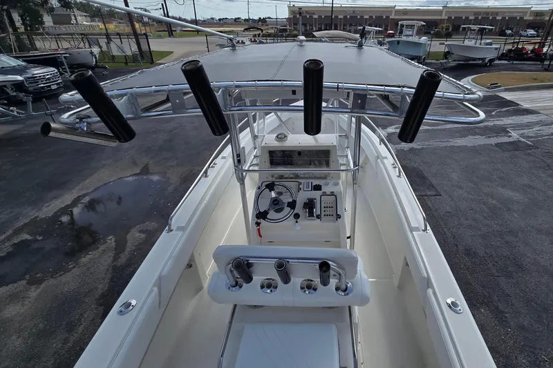 Slide: The Image of 1998 Fountain 25 Center Console boat interior with steering wheel and rod holders. - 14