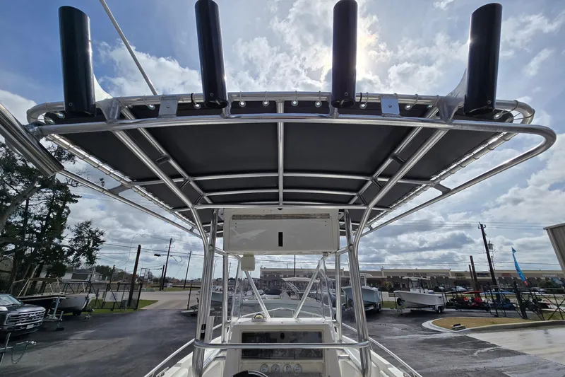 Slide: The Image of 1998 Fountain 25 Center Console boat with T-top and rod holders, viewed from the deck. - 15