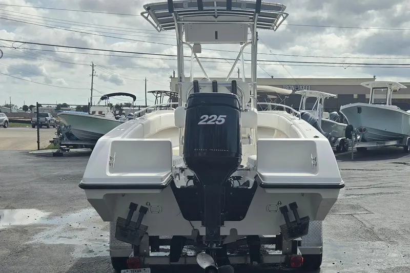 Slide: The Image of 1998 Fountain 25 Center Console boat with 225 horsepower engine, parked outdoors. - 4